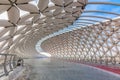 Modern architectural urbanistic Atyrau fish bridge across Ishim river. Pedestrian bridge with graceful fish scales