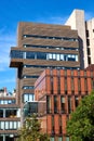 Modern architecture on the Barnard U. Campus, in colors of brown and red, against a blue sky
