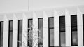 Modern office building wall made of steel and glass with blue sky. Black and white. Royalty Free Stock Photo