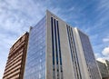 Modern architecture, glass facade with windows of residential or commercial, office building on a sunny day Royalty Free Stock Photo