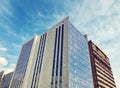 Modern architecture, glass facade with windows of residential or commercial, office building on a sunny day Royalty Free Stock Photo