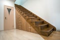 Modern architecture interior with luxury hallway with glossy wooden stairs in multi-storey house. Custom built pullout cabinets on Royalty Free Stock Photo