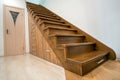 Modern architecture interior with luxury hallway with glossy wooden stairs in multi-storey house. Custom built pullout cabinets on Royalty Free Stock Photo