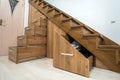 Modern architecture interior with luxury hallway with glossy wooden stairs in multi-storey house. Custom built pullout cabinets on Royalty Free Stock Photo