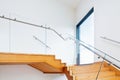 Modern architecture interior with wooden stairs Royalty Free Stock Photo