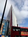 Modern architecture in London - sharply-edged, wedge-shaped building double decker bus. Royalty Free Stock Photo