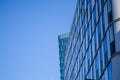 Modern architecture of office buildings. A skyscraper from glass and metal. Reflections in windows of blue sky. Business center. Royalty Free Stock Photo