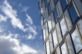 Modern architecture with reflection of clouds and blue sky Royalty Free Stock Photo