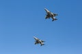 Modern armed military fighter jets flys in formation through the sky