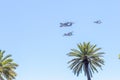 Modern armed military transport planes flys in formation through the sky