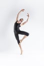 Modern Art Ballet of Young Caucasian Athletic Man in Black Suit Dancing in Studio Over White Background With Lifted Hands Royalty Free Stock Photo