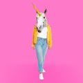 Modern art collage. Woman with unicorn`s head on pink background Royalty Free Stock Photo