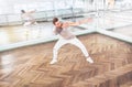 Modern art dancer teenager practices a dance movements in mirror hall