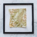 Modern art painting in frame hanging on the white wall Royalty Free Stock Photo