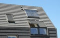 Modern attic roof with solar panels, skylights and blinds window for sun protection and house energy efficiency Royalty Free Stock Photo