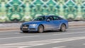 Modern Audi A6 auto drive fast on the road. Fast moving blue car with motion blur effect. overspeed concept