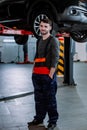 In a modern auto service center closeup to the camera mechanic man charismatic showing smile cute