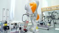 Modern automated hand in enterprise. Scene. Automated robot arm for rearranging finished parts in modern factory. Modern