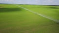 Modern automated irrigation equipment watering freshly seeded field. Irrigation of farmland to ensure the quality of the