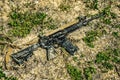 A modern automatic American carbine lying on the ground in the mud. Weapons in extreme conditions. Testing weapons for strength, Royalty Free Stock Photo