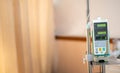 Modern automatic Infusion pump for control infuses fluids medication or nutrients sodium chloride saline solution fluid hanging at Royalty Free Stock Photo