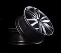 Modern automotive alloy wheel made of aluminum on a black background, industry. Designer fashion wheels for car Royalty Free Stock Photo