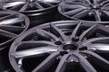 Modern automotive alloy wheel made of aluminum on a black background, industry. Designer fashion wheels for car Royalty Free Stock Photo