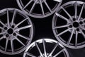 Modern automotive alloy wheel made of aluminum on a black background, industry. Designer fashion wheels for car Royalty Free Stock Photo