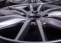 Modern automotive alloy wheel made of aluminum on a black background, industry. Designer fashion wheels for car Royalty Free Stock Photo