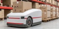 Autonomous Delivery Robot in Warehouse Setting Carrying Cardboard Boxes on Stacked Pallets Royalty Free Stock Photo