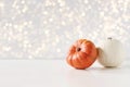 Modern autumn styled composition. White and orange pumkins on white table background. Halloween, Thanksgiving party