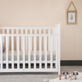 Modern baby room interior with a cozy classic crib and miniature toys placed on a soft carpet Royalty Free Stock Photo