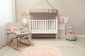 Modern baby room interior with stylish crib Royalty Free Stock Photo