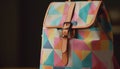 Modern backpack with leather handle, multi colored pattern generated by AI