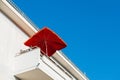 Modern balcony with red sunshade at a luxury Royalty Free Stock Photo