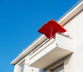 Modern balcony with red umbrella sunshade at a luxury real estate penthouse Royalty Free Stock Photo