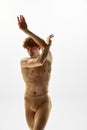 Modern ballet dancer. Portrait of half-naked handsome young man raising hands and demonstrating his athletic body Royalty Free Stock Photo