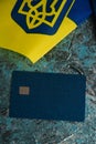 Modern bank card with chip close-up, flag of Ukraine and Ukrainian passport. The concept of departure of Ukrainians Royalty Free Stock Photo