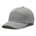 Modern baseball cap in light gray fabric with structured design Royalty Free Stock Photo