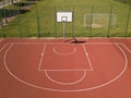 Modern basketball court in the courtyard of primary school. Multifunctional children`s playground with artificial surfaced fenced