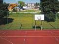 Modern basketball court in the courtyard of primary school. Multifunctional children`s playground with artificial surfaced fenced Royalty Free Stock Photo