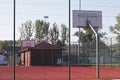 Modern basketball court in the courtyard of primary school. Multifunctional children`s playground with artificial surfaced fenced Royalty Free Stock Photo