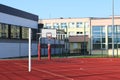 Modern basketball court in the courtyard of primary school. Multifunctional children`s playground with artificial surfaced fenced Royalty Free Stock Photo