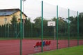 Modern basketball court in the courtyard of primary school. Multifunctional children`s playground with artificial surfaced fenced Royalty Free Stock Photo