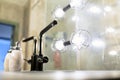 Modern bath room with all facilities, very comfortable look, lights, mirror. A bottle of liquid soap near the washbasin Royalty Free Stock Photo