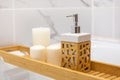 Modern bath room with wooden table and candles. White marble background wall Royalty Free Stock Photo