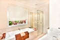 Modern bathroom with bath tub and bathing area prepared with towels Royalty Free Stock Photo