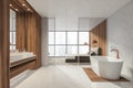 Modern Bathroom bedroom interior in new luxury home. Stylish hotel room. Open space area. Wooden walls concrete floor. Bathtub and Royalty Free Stock Photo