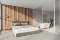 Modern Bathroom bedroom interior in new luxury home. Stylish hotel room. Open space area. Wooden walls concrete floor. White Royalty Free Stock Photo