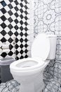 Modern bathroom design featuring artistic wall patterns and checkerboard tiles. Royalty Free Stock Photo
